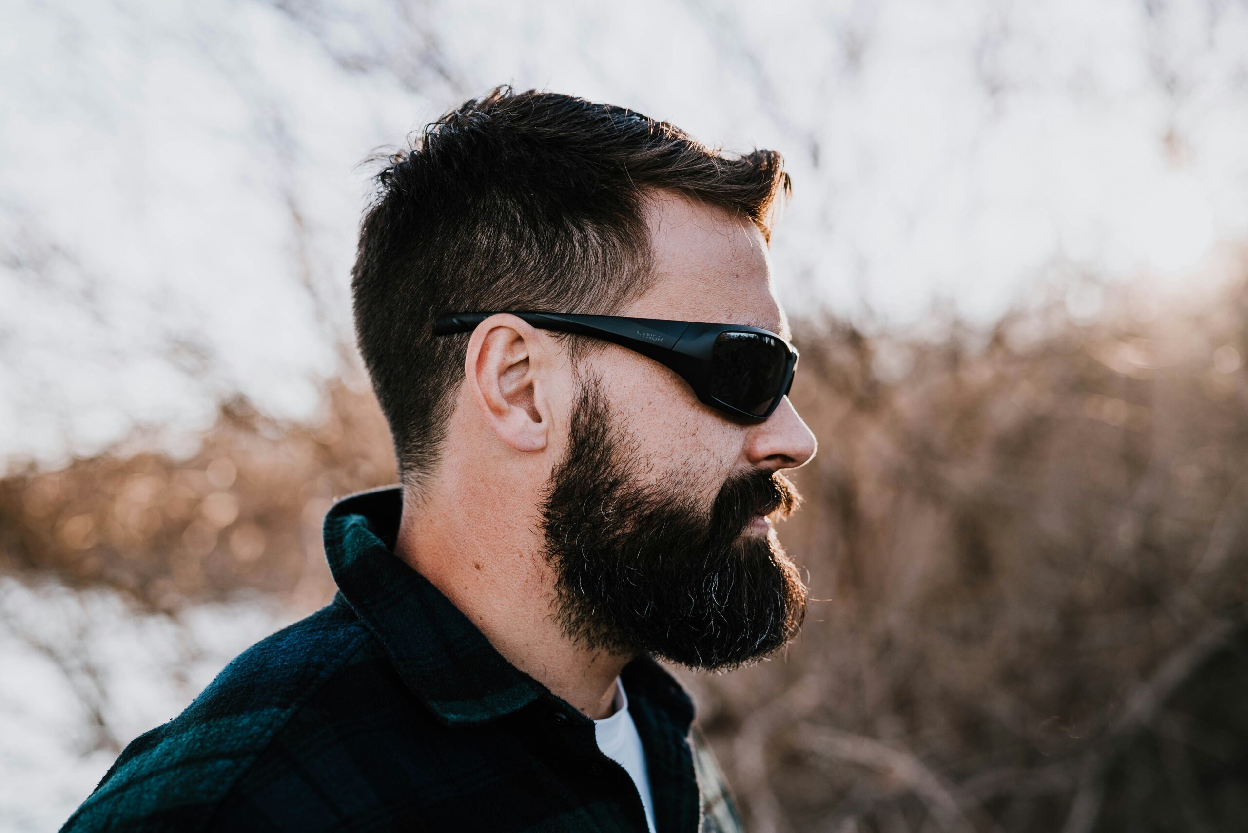 man in blue and black jacket wearing black sunglasses